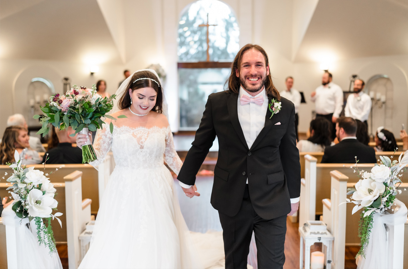 Groom kissing bride in front of wedding chapel in Colorado