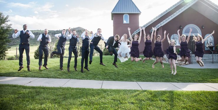 Wedding party celebrating in front of wedding chapel