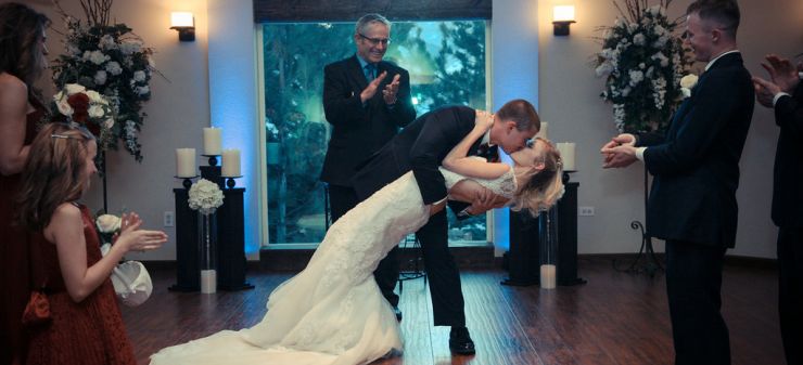 bride and groom kiss inside wedding chapel